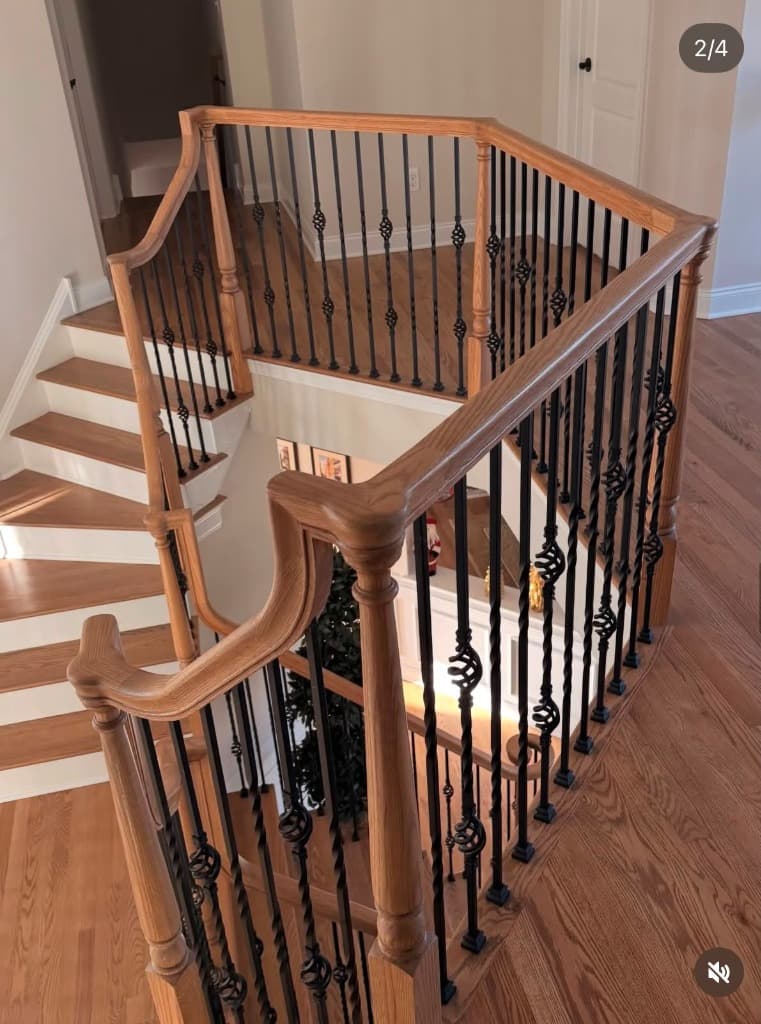 Custom oak handrail with decorative iron balusters